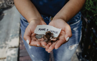 hands holding change and a not that says "make a change"